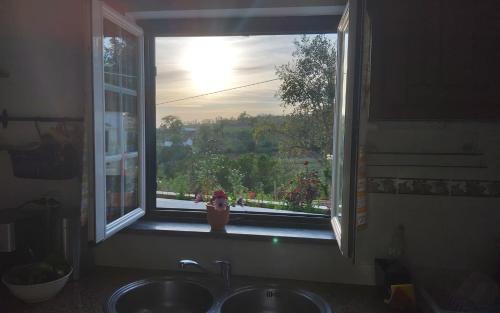 a window in a kitchen with a sink and a view at Casa do Brejão 1 bedroom cottage in Odemira