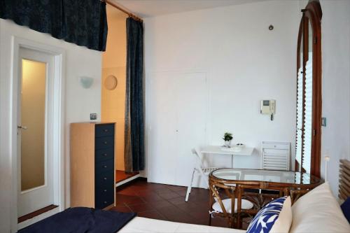a room with a bed and a table and a desk at BLU RAITO costa d'Amalfi in Vietri sul Mare