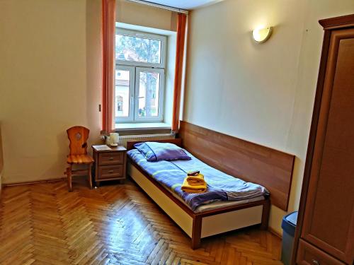 um pequeno quarto com uma cama e uma janela em "Aleksandrówka" Restauracja i Noclegi em Horyniec