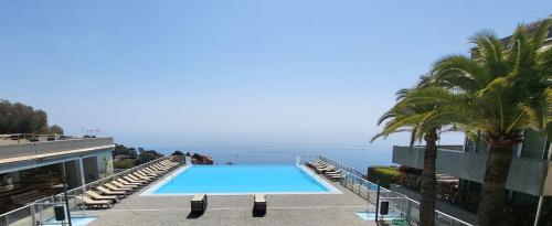 a swimming pool with a view of the ocean at Cap Monaco in Cap d'Ail