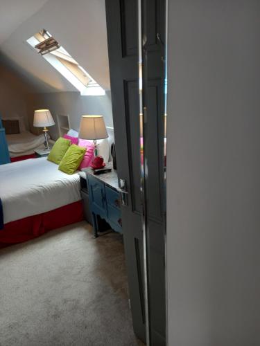 a bedroom with a bed and a window at Baywatch Inn in Dingle