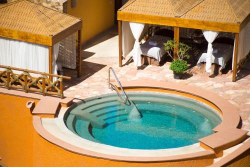 an overhead view of a swimming pool with a gazebo at Playa Grande Resort in Cabo San Lucas