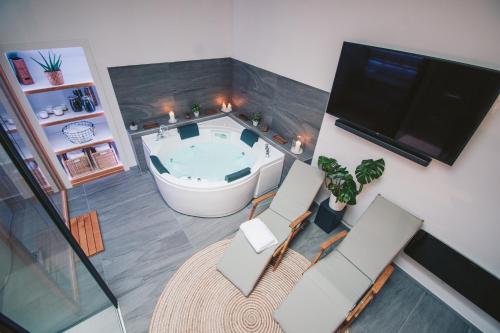 an overhead view of a room with a tub and a tv at NA Apartments in Maribor