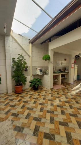 an empty room with plants on the floor at Pousada Executiva SolRiso Aeroporto Florianópolis in Florianópolis