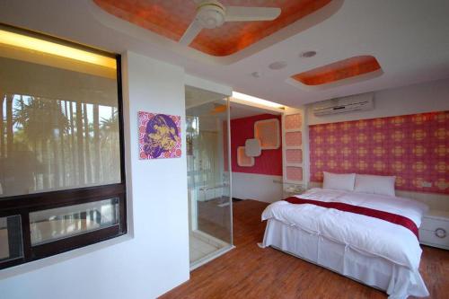 a bedroom with a bed and a sliding glass door at Full House Homestay in Yuchi