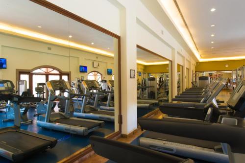 a gym with a large mirror and cardio machines at The Ridge at Playa Grande All Inclusive in Cabo San Lucas