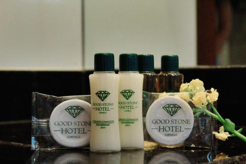 un groupe de quatre bouteilles de produits de toilette sur un comptoir dans l'établissement Good Stone Curvelo Hotel, à Curvelo