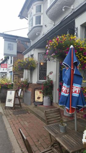 an umbrella sitting on a table in front of a building at Castle Hotel in Eynsford
