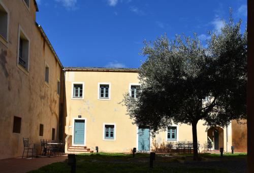 a large yellow building with a tree in front of it at GITE DU COUVENT-Scala in Canari
