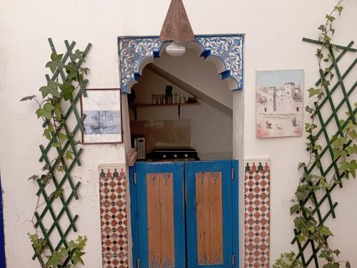an entrance to a kitchen with a colorful door at RIAD DAR LFONOUN in Marrakech