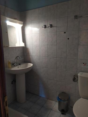 a bathroom with a sink and a toilet at Triple studio room in Mylopotamos Beach in Tsagarada