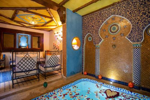 a large swimming pool in a room with a shower at Riad Christina in Marrakesh