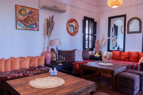 a living room with a couch and a table at Kasbah Caracalla in Aghmat