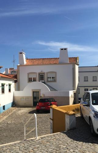 a car parked in a parking lot in front of a house at Maré Baixa in Sines