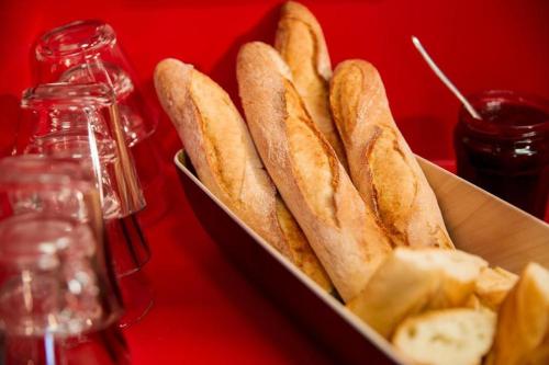 a box of french bread and chips on a red table at Eco hôtel Rouen Louviers Val de Reuil in Val de Reuil