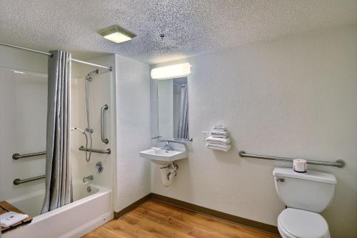 a bathroom with a toilet and a sink and a shower at Motel 6-Tewksbury, MA - Boston in Tewksbury