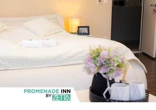 a bedroom with a white bed with flowers in a basket at Promenade Inn by ZETTA in Sarajevo