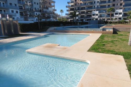 a swimming pool in front of a building at Mil Palmeras - Bioko 208 - apartment for 6 in Pilar de la Horadada