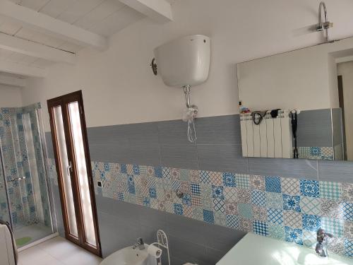 a bathroom with a sink and a mirror at Villa angiole in Castellonorato