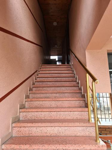 a set of stairs in a building at Bar Kafe Pjetri Guest House in Patza-Kuqani