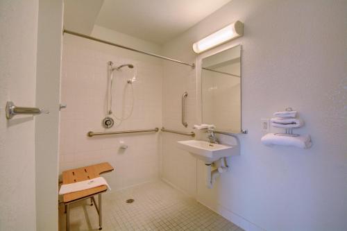 a white bathroom with a sink and a shower at Motel 6-Wethersfield, CT - Hartford in Wethersfield