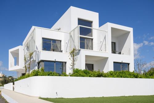 an image of a white house at CUBES ON THE BEACH Athens Airport in Artemida