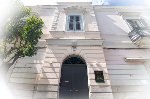 a white building with a black door and a window at DEAS B&B in Trani