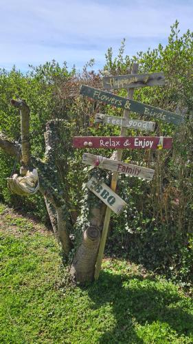 a street sign with signs on it in the grass at Roos Guesthouse Holiday Appartements in Valkenburg
