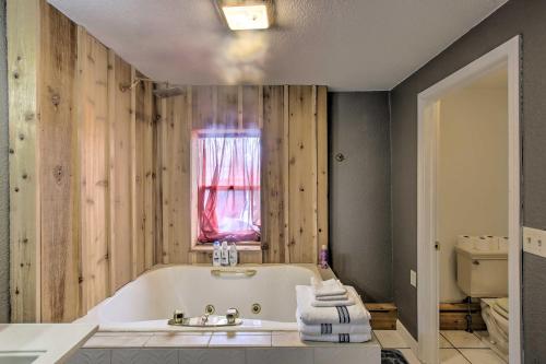 a bathroom with a tub and a sink and a window at Spacious Sheboygan Home with Grill and Fire Pit! in Sheboygan