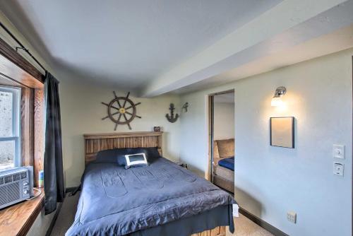 a bedroom with a large bed and a clock on the wall at Spacious Sheboygan Home with Grill and Fire Pit! in Sheboygan