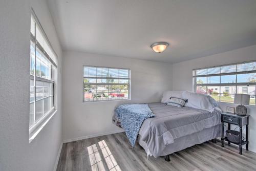 a bedroom with a bed and two windows at Gulf Views and Boat Dock Sunny Hudson Escape! in Hudson