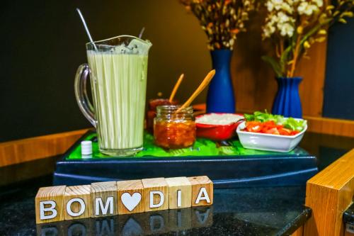 a table topped with a drink and a bowl of food at ibis Rio de Janeiro Nova America in Rio de Janeiro