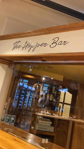 a store window with a sign that reads the higher bar at Hotel Salvators in Bruges