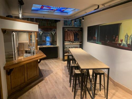 a kitchen with a table and stools in a room at Hotel Salvators in Bruges