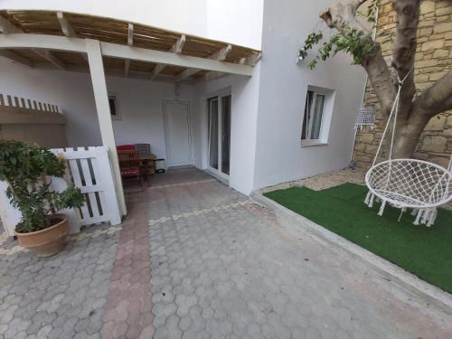 a patio with a bench and a tree in a house at Antonios 1 in Matala