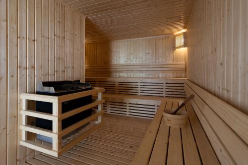 an empty wooden sauna with a bucket in it at Laguna Grand Hotel & Spa Songkhla in Songkhla