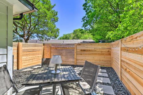 a patio with two chairs and a table and a fence at Remodeled Zilker Townhome with Yard Walk to SXSW! in Austin