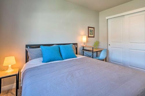 a bedroom with a large bed with blue pillows at Charming Home with Mtn and Columbia River Views! in East Wenatchee