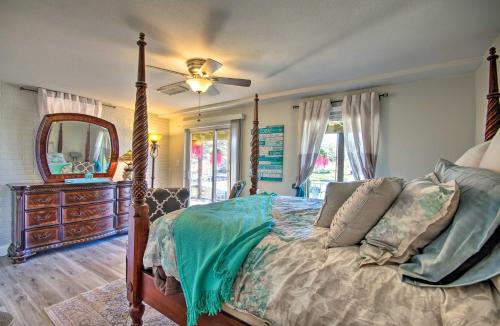 a bedroom with a bed and a dresser and a mirror at Sunrise Beach Home with Serene Waterfront Views in Sunrise Beach