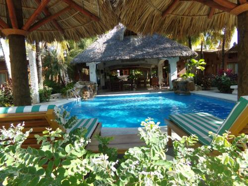 a swimming pool with a gazebo in a resort at Hotel Casa de Lirio Diamante in Acapulco