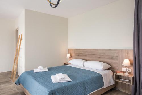 a bedroom with a bed with two towels on it at Dinas's Cottage Ideal Base for Balos and Elafonisi in Kaloudhianá