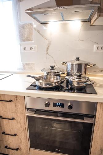 a kitchen with two pots on top of a stove at Dinas's Cottage Ideal Base for Balos and Elafonisi in Kaloudhianá