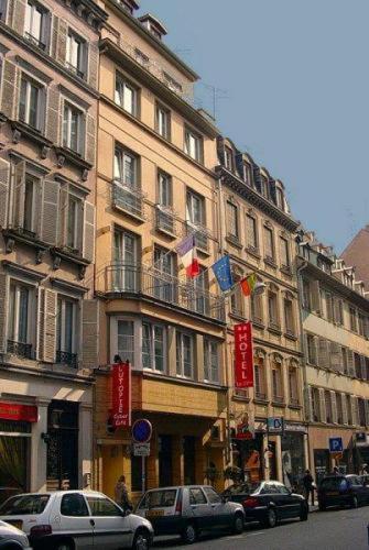 a tall building with cars parked in front of it at Hotel Le 21ème in Strasbourg