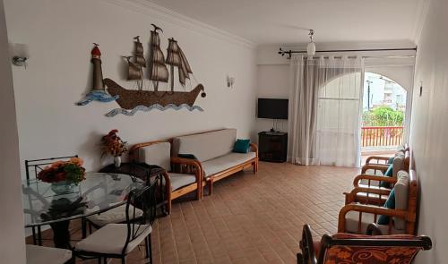 a living room with a couch and a glass table at شاليه بحديقة يري البحر , بانوراما بيتش ريزورت , الساحل الشمالي The North Coast , Sea View Garden Chalet in El Alamein