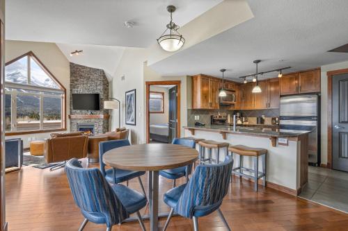 a kitchen and living room with a table and chairs at Stoneridge Mountain Resort Condo managed by Little Sister Getaways in Canmore