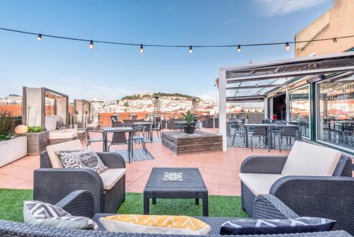 a patio with chairs and tables on a roof at The ART INN Lisbon in Lisbon