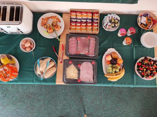 una mesa cubierta con platos de comida y tazones de comida en Honeysuckle Homestead en Dinton