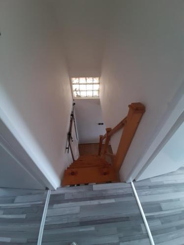 a room with a staircase with a window in it at Grapeline Guesthouse in Chotín
