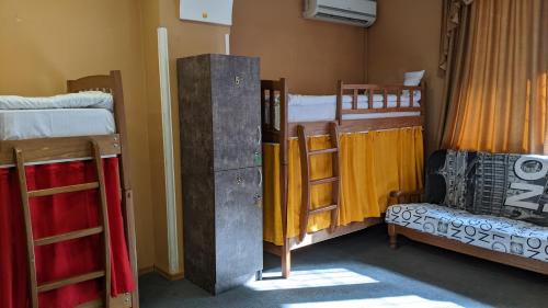 a room with two bunk beds and a bed at Museum Hostel in Tbilisi City