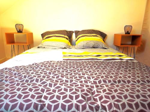 a bedroom with a large bed with two night stands at Le 3plex - Coeur de Vertou - Original in Vertou